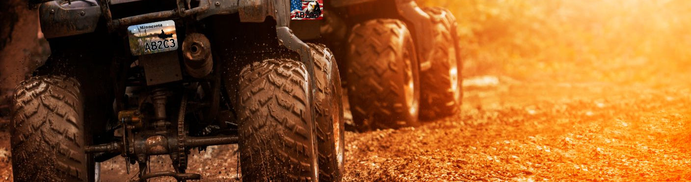 Two ATV's with cool custom license plates.